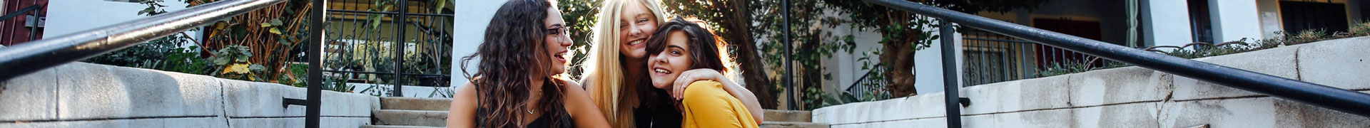 Mother and her two daughters laughing